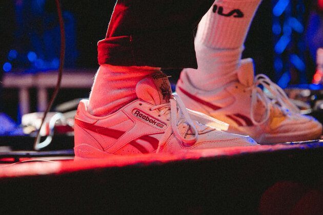 舞台の上で反射した赤いライトに浮かび上がる靴